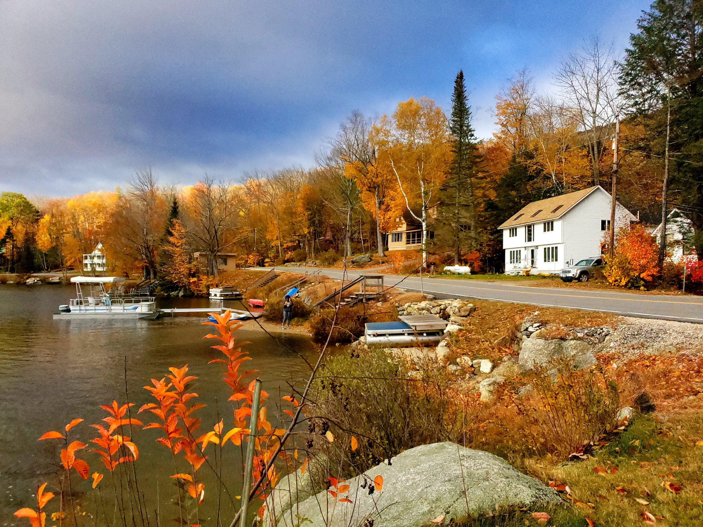 white house and boat on fall day in harbor