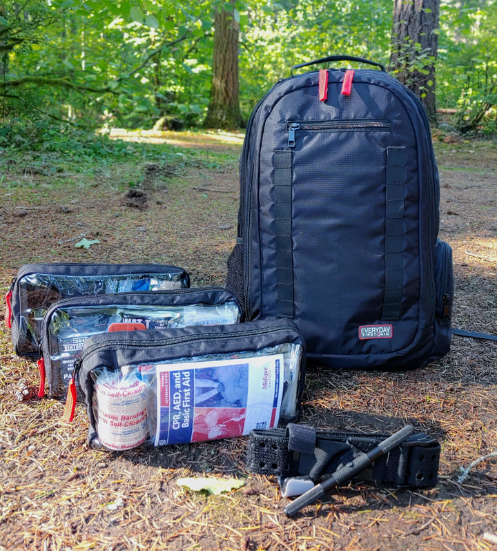 First aid kit backpack with pouches out in the woods