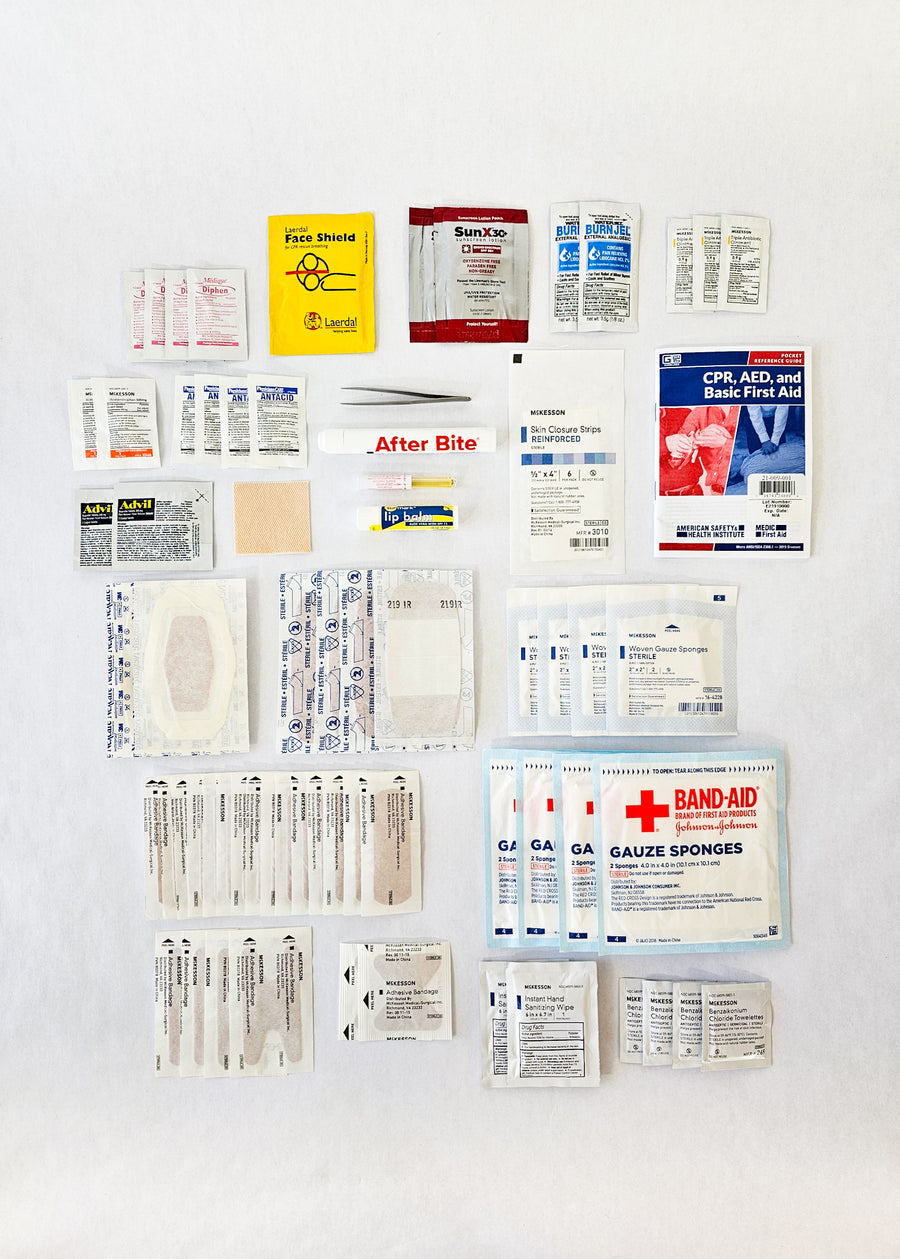 black first aid kit contents bandages gauze tweezers