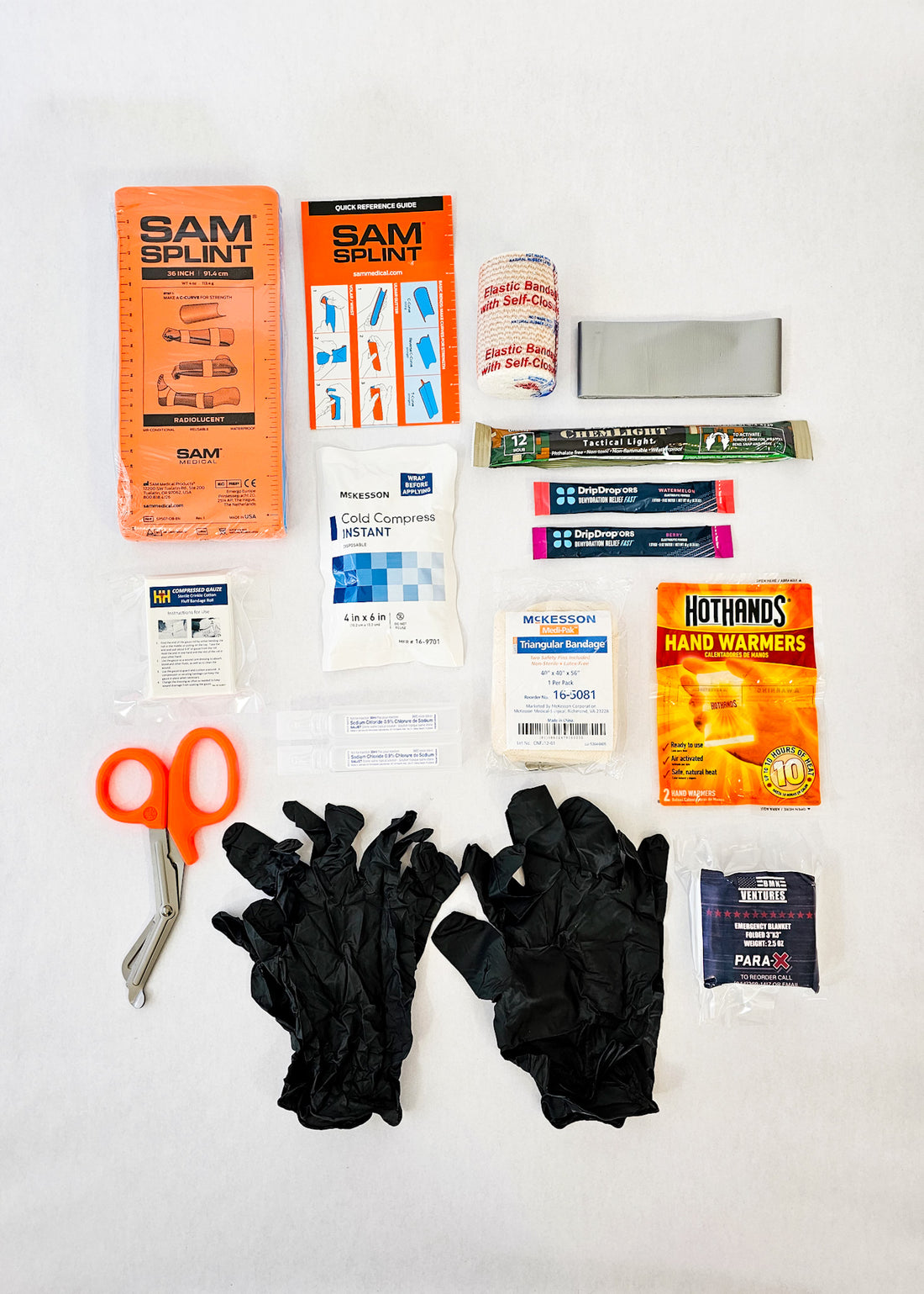 black first aid kit contents splint latex gloves trauma shears triangle bandage