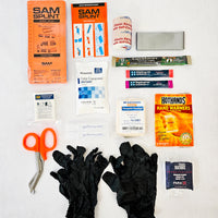 black first aid kit contents splint latex gloves trauma shears triangle bandage