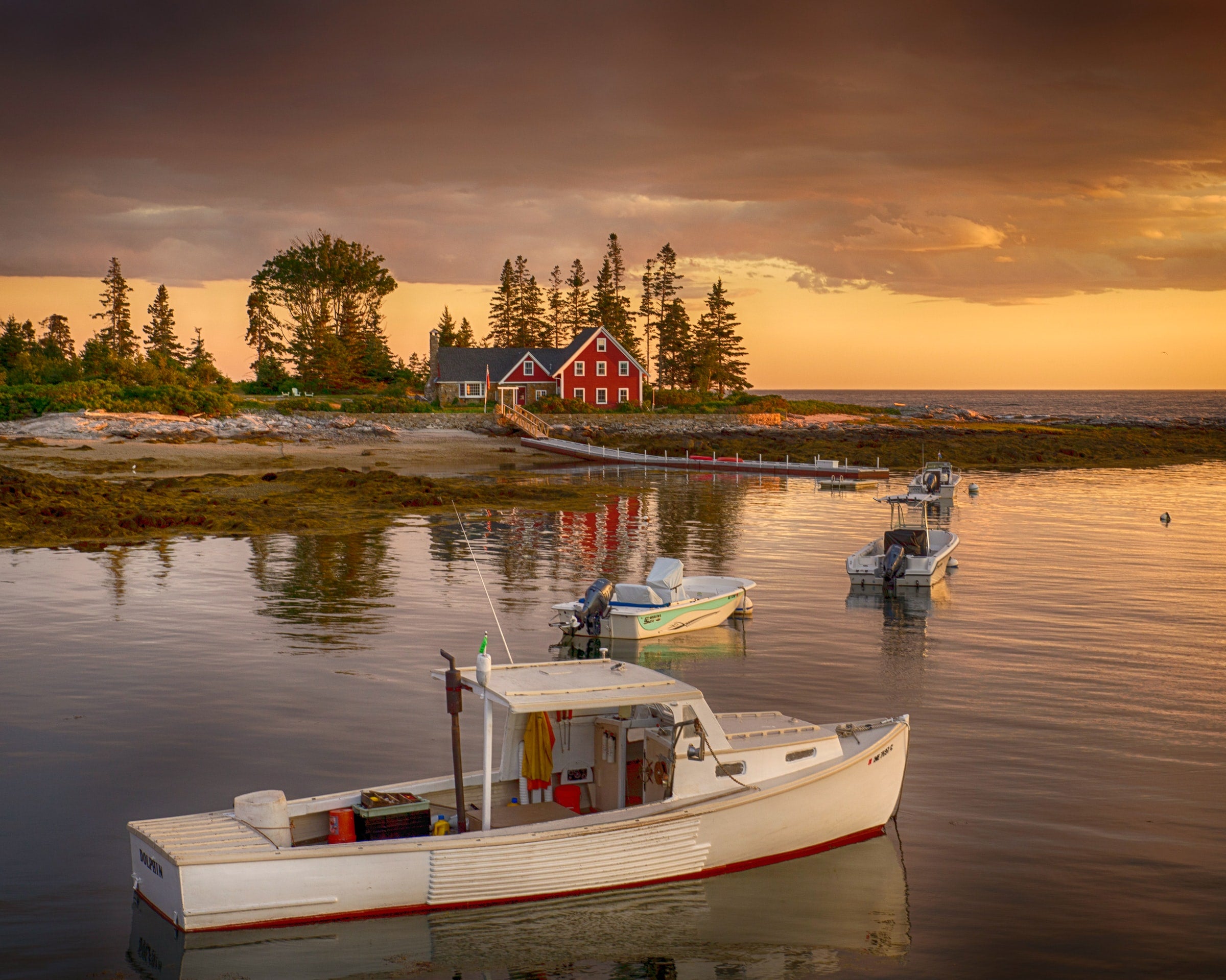 small boat on water at sunset in maine