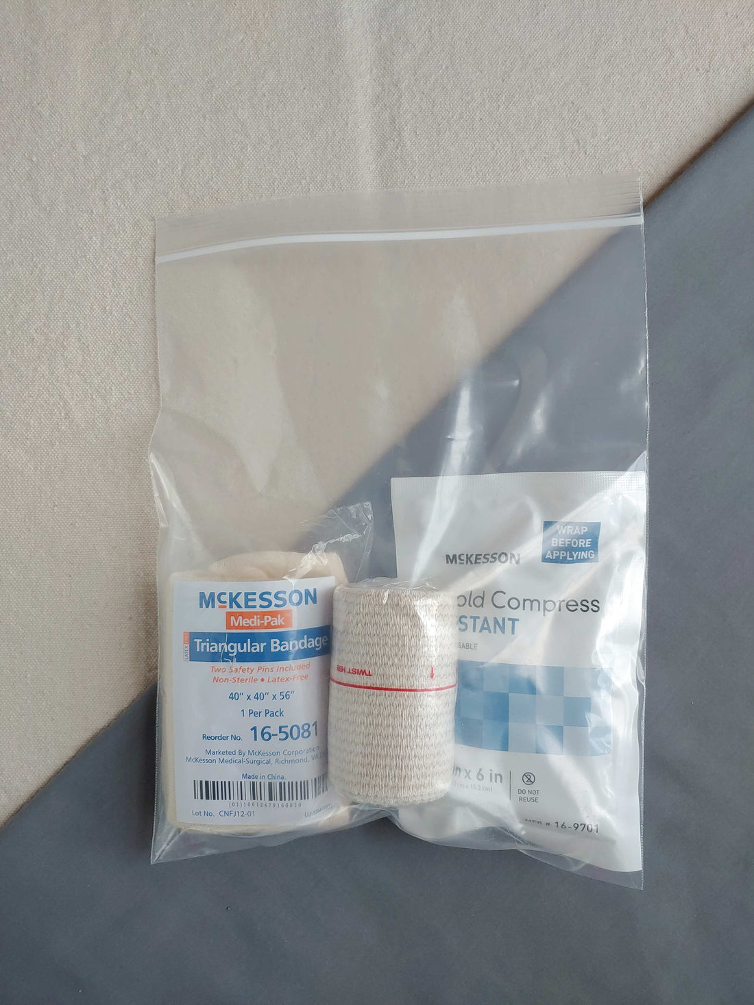 First aid kit refill containing ice pack elastic bandage and triangle bandage in baggie