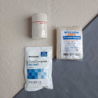 First aid kit refill containing ice pack elastic bandage and triangle bandage
