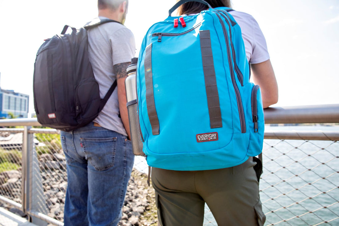 Man and woman wearing advanced first aid kit backpacks