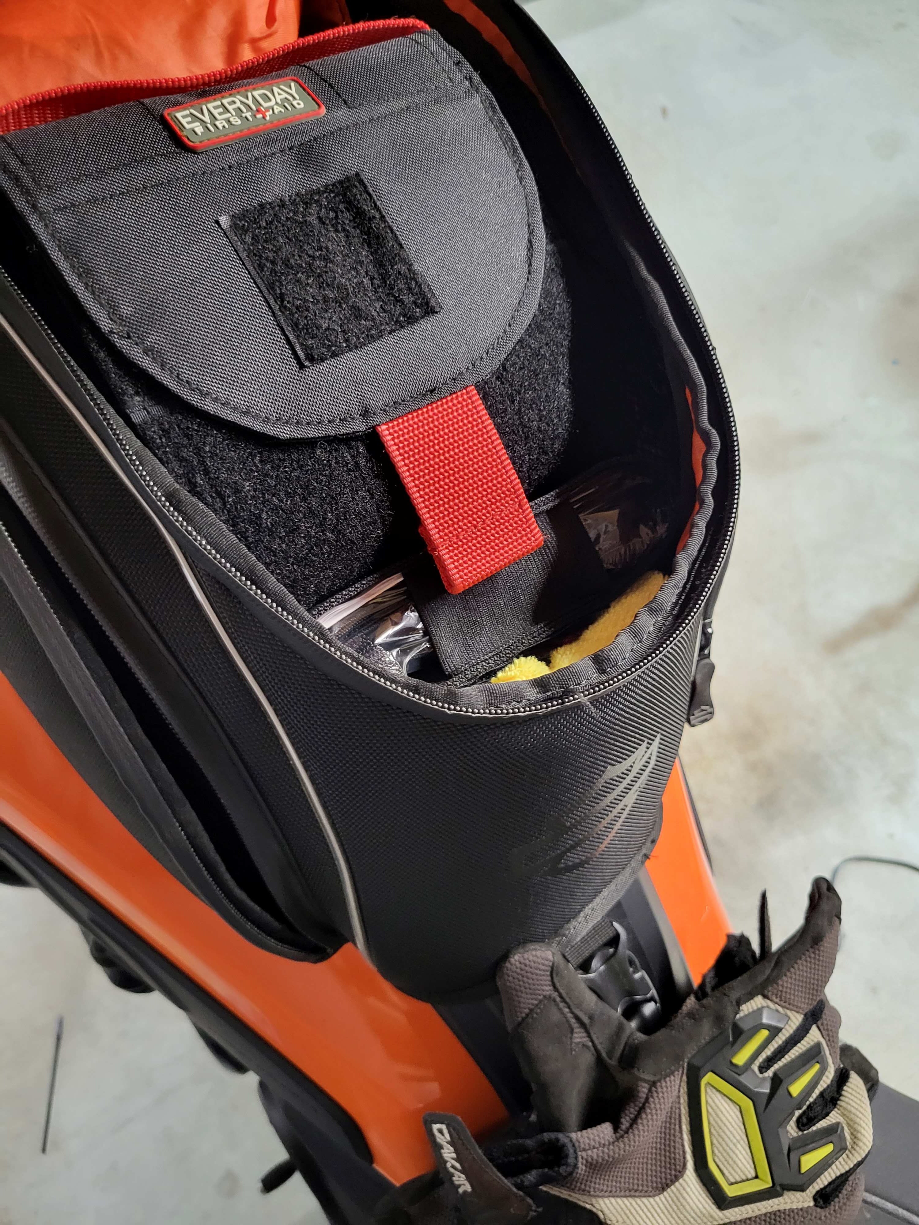 Black motorcycle first aid kit inside tank bag